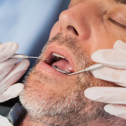 An expert dentist is performing a routine dental checkup.