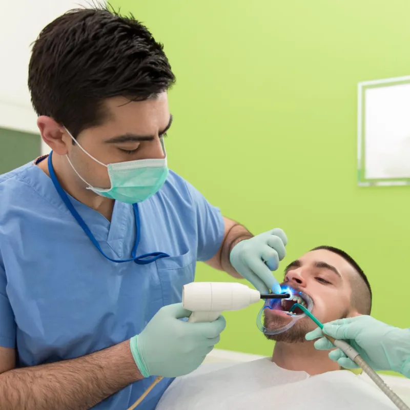 Dentist performing professional Dental Implants for a patient in Maabila , Oman