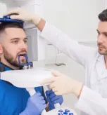 Patient undergoing a dental X-ray scan for accurate diagnosis of teeth, jaw, and oral health conditions.