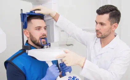 Patient undergoing a dental X-ray scan for accurate diagnosis of teeth, jaw, and oral health conditions.